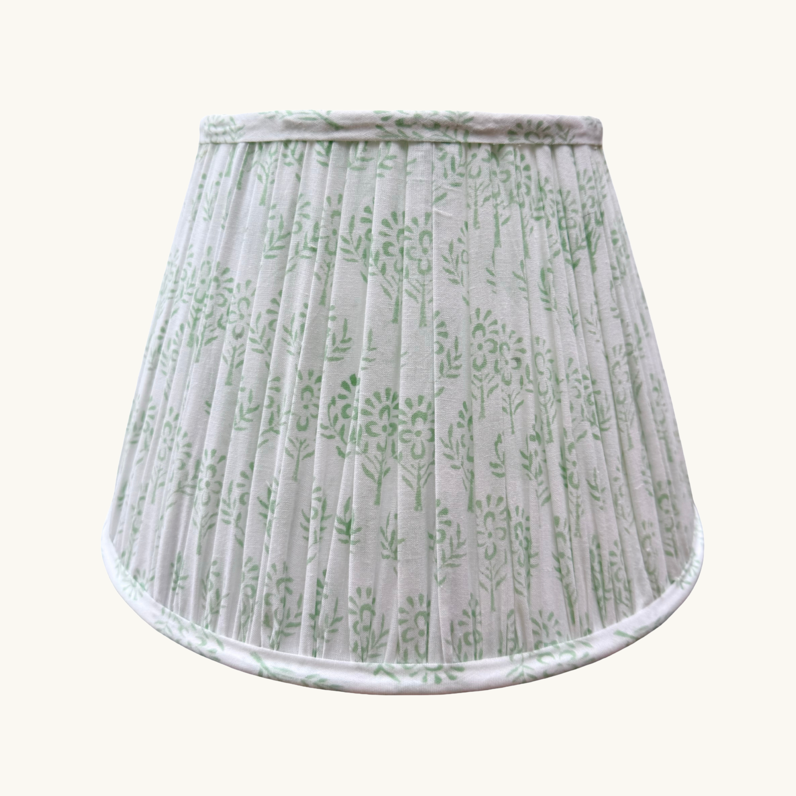 Lampshade with green leaf pattern on a white background